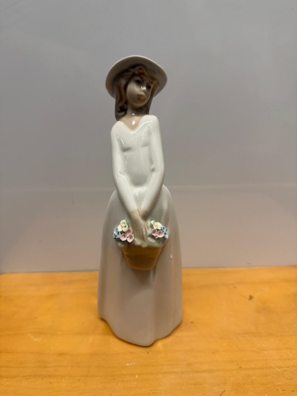 Princess House "Regina" glazed porcelain figurine a lady in a basket of flowers